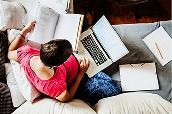 Person multitasking with notes and computer