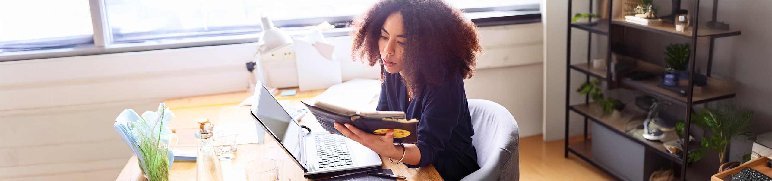 Person researching plan information on a device at home