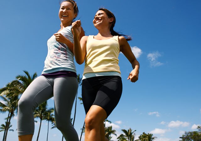 Photo of two women jogging near palm trees Photo of two women jogging near palm trees