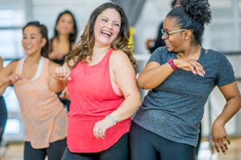 Friends laughing in an exercise class 