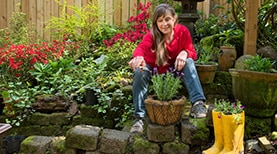 woman-sits-and-tends-to-garden