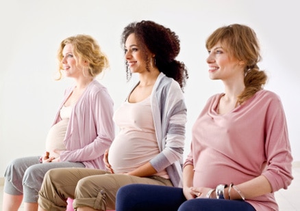 three pregnant women sitting