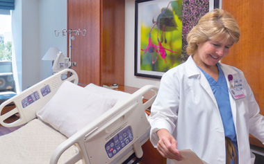 smiling nurse in hospital room