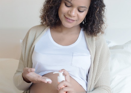 pregnant woman with lotion