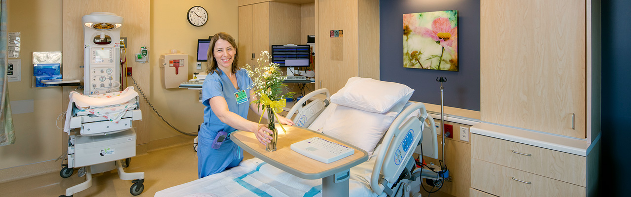 nurse putting flowers in exam room