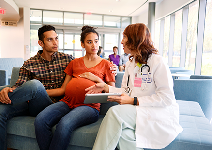 Pregnant couple talks with doctor