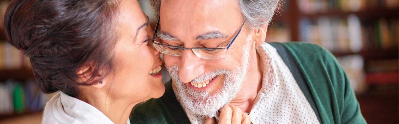 Woman kissing an elderly man on the cheek