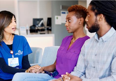 Couple discussing cancer diagnosis with nurse