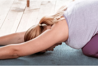 Person doing a yoga class at home with their laptop