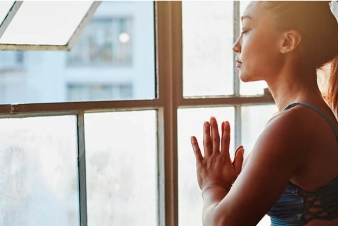 Person pressing palms together meditating