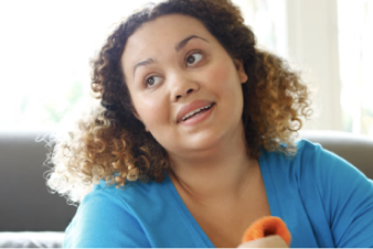 Person sitting on living room floor stretching