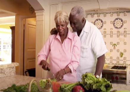 happy couple prepares food together at home