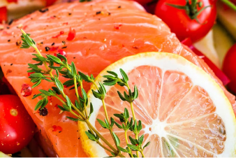 Person seasoning salmon fillets before cooking them