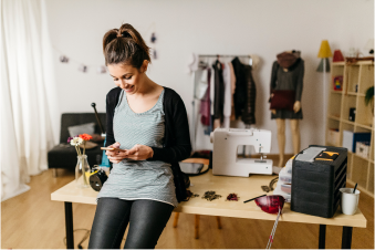 Young woman looking at her phone smiling