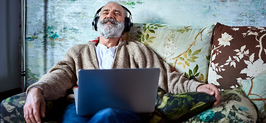 Man reclining listening to headphones