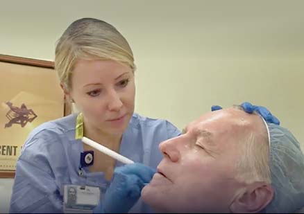 nurse examines patients skin