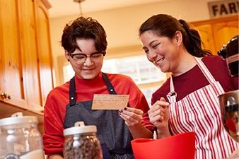 Parent and child reading a recipe