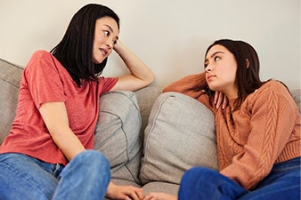 Parent and teenager talking at home