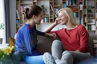 Parent and teenager talking at home