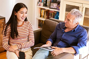 Parent and teenager talking at home