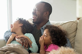 Parent smiling next to their children