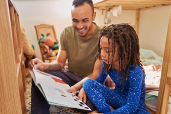 Parent reading their child a bedtime story