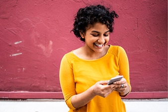 Smiling teenager using their smartphone