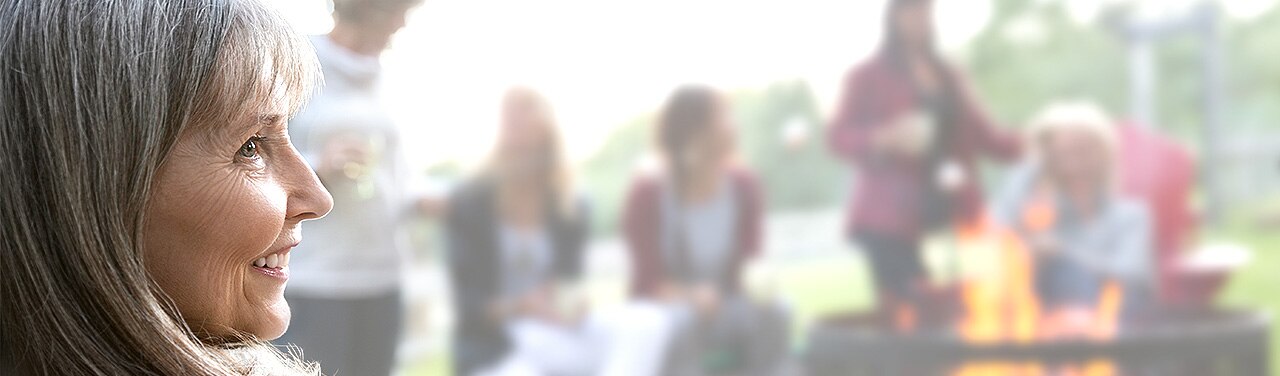 Smiling woman sits near friends