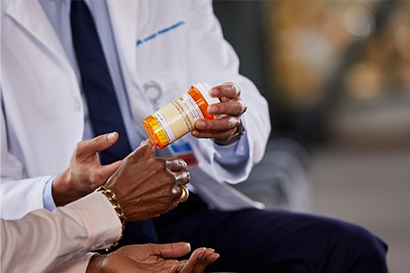 Doctor holding prescription bottle