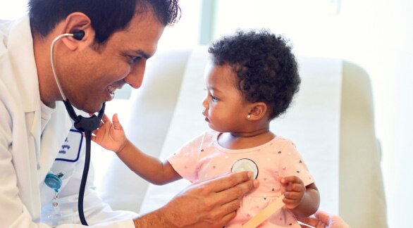 Doctor listening to a baby's heartbeat