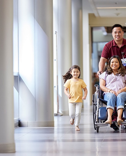 Nurse pushing a patient in a wheelchair