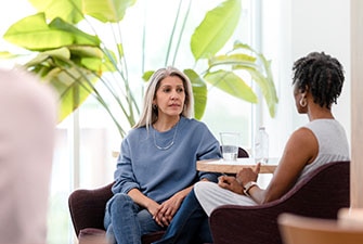 2 people sitting at a table talking