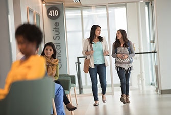 Parent and teen talking in a medical building