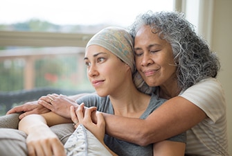 Person hugging a loved one with cancer