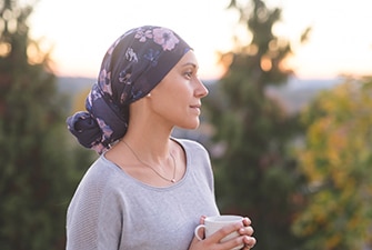 Person with cancer relaxing outdoors