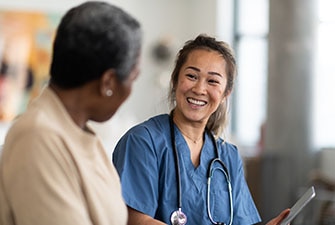 Smiling doctor talking with their patient