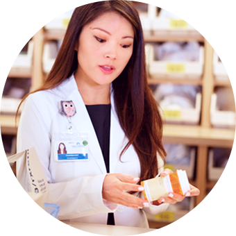 Pharmacist preparing a prescription bottle.