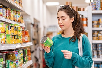 Person reading canned food label
