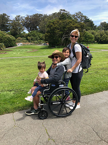 Cheong and family pose for picture in wheelchair.