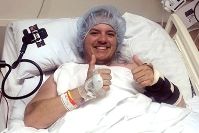 Trans patient giving a thumbs-up after surgery