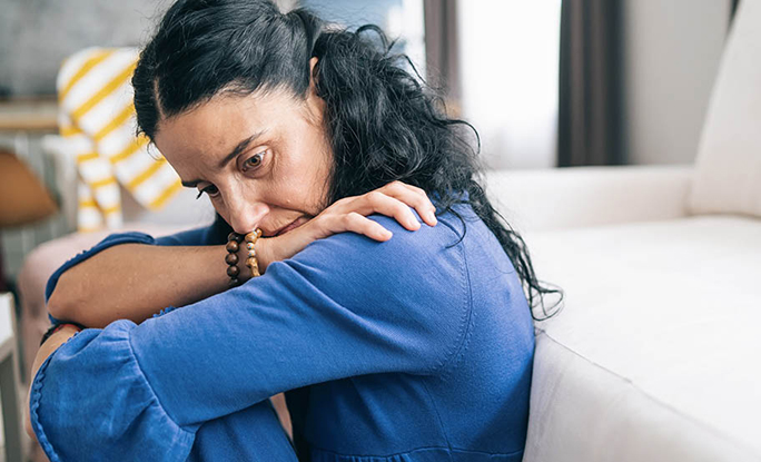 Person sitting anxiously at home