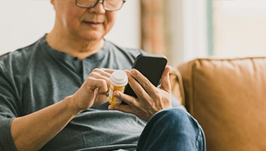 man reviews info on smartphone