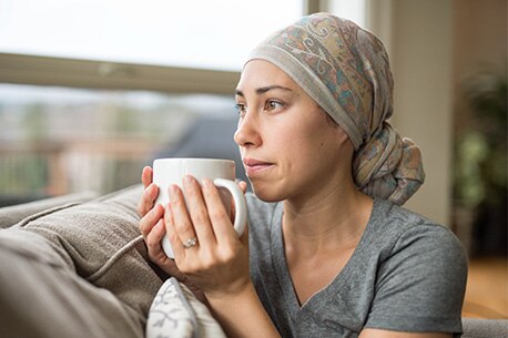 Person sitting by window drinking beverage