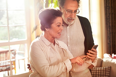 senior couple look at phone