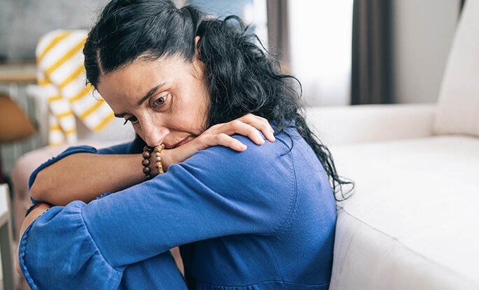 Person sitting anxiously at home