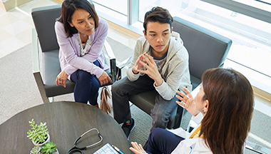 Family receiving medical consultation from a health care professional