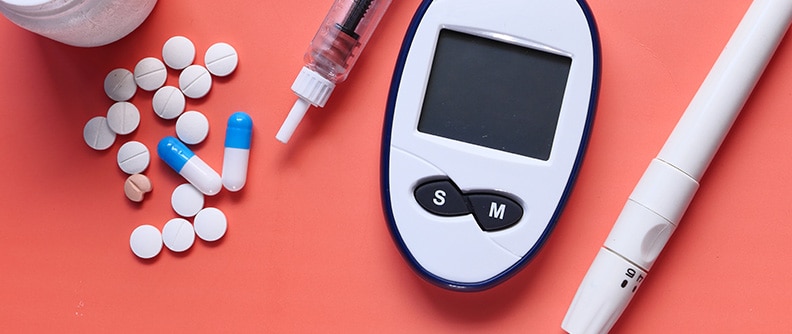 Photo of diabetes medication and testing tools on a table